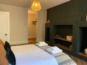 a bedroom with a large bed with two towels on it at Royal Bolthole in Edinburgh