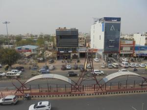 a view of a city with a parking lot with cars at Hotel Raj Guest House in Jaipur