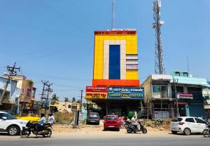 a group of people riding motorcycles in front of a building at Royal Residency in Pedappai