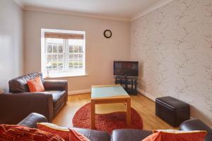 a living room with a couch and a table and a tv at Host & Stay - Seal Watch in Whitby