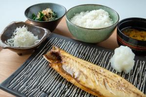 a plate of food with rice and a fish at Sunrise Choshi in Choshi