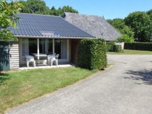 a house with a table and chairs in the yard at Child friendly apartment on a farm with garden in Fochteloo in Fochteloo