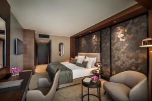 a hotel room with a bed and two chairs at Hotel Ambasador - Liburnia in Opatija +37 photos