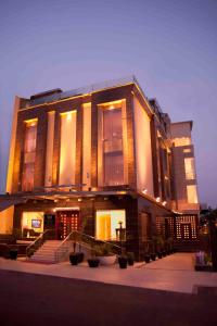 a large building with a staircase in front of it at Hotel Eternity in New Delhi