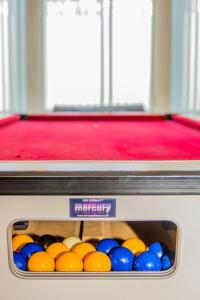 a box of pool balls in front of a pool table at Lushlets - Riverside City Centre House with Hot tub and pool table - great for groups! in Cardiff