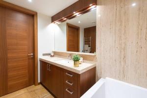a bathroom with a sink and a mirror at Cozy river-side apartment right in Riga in Rīga +13 photos