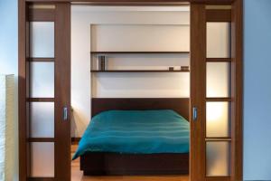 a bedroom with a bunk bed with glass shelves at Cozy river-side apartment right in Riga in Rīga