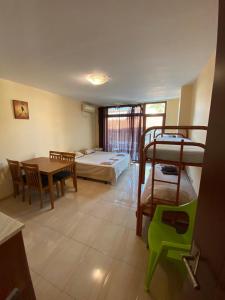a room with a bedroom and a bed and a table at Студио- Плажна Улица in Sozopol