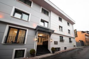 a white building with stairs in front of it at Kare Hotel Sultanahmet in Istanbul