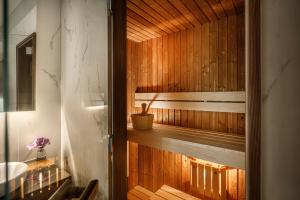 a bathroom with a wooden sauna with a sink at Hotel Ambasador - Liburnia in Opatija
