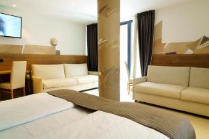 Postel nebo postele na pokoji v ubytování Hotel Bellevue