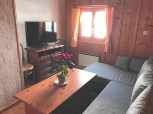 a living room with a couch and a table at Le Biolley 2 in Orsières