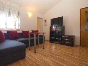 a living room with a couch and a table at Holiday Home Mario in Pula