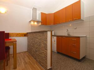 a kitchen with orange cabinets and a counter top at Holiday Home Mario in Pula