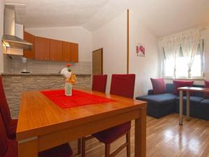 a kitchen and dining room with a table with a toy on it at Holiday Home Mario in Pula