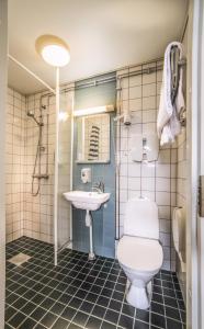 a bathroom with a toilet and a sink at Jugend Boutique Hotel in Pietarsaari