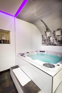 a bath room with a tub and a sink at L'Empire Paris in Paris
