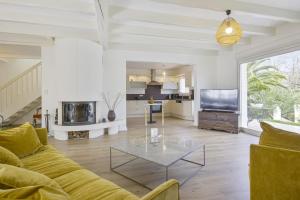 a living room with a couch and a table at La Maison Mora - Welkeys in Boucau