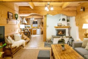 a living room with wooden ceilings and a fireplace at Domki Pod Reglami in Zakopane