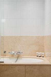 a bathroom with a sink and a shower at Hôtel de l'Abbaye in Paris