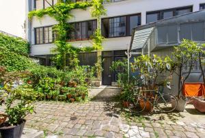 a building with plants in front of it at CMG Saint Louis- Vaucouleurs in Paris