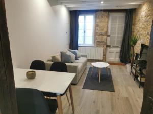 a living room with a couch and a table at Villas Chapu in Fontainebleau