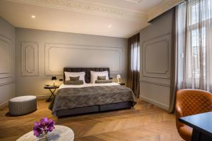 a hotel room with a large bed and a large window at Hotel Ambasador - Liburnia in Opatija