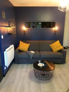 a living room with a couch and a table at Appartement Alpin à 200m des pistes pour 6 in Val Louron