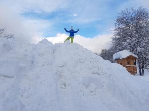 a man standing on top of a pile of snow at Residence Alice in Celledizzo