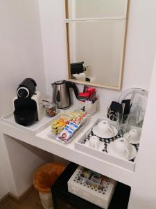 a white shelf with dishes and a mirror at La Maison De Charme ROOMS in Verona +19 photos