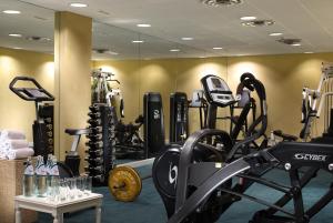 a gym with several treadmills and exercise bikes at Royal Olympic Hotel in Athens