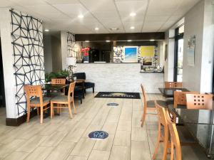 a restaurant with tables and chairs and a counter at Days Inn by Wyndham Asheville Downtown North in Asheville