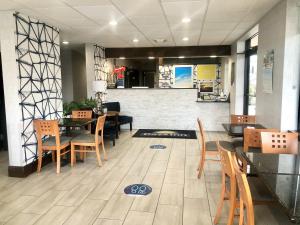 a restaurant with tables and chairs and a counter at Days Inn by Wyndham Asheville Downtown North in Asheville