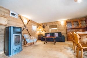 a living room with a couch and a tv at Maison Glarey Courmayeur CIR VdA 0023 in Courmayeur