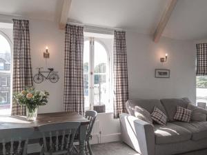 a living room with a couch and a table at Crescent View in Buxton