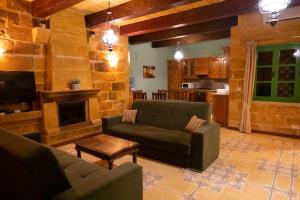 a living room with a couch and a fireplace at Prickly Pear Holiday Home No. 3 in San Lawrenz