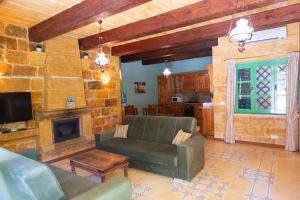 a living room with a couch and a fireplace at Prickly Pear Holiday Home No. 3 in San Lawrenz