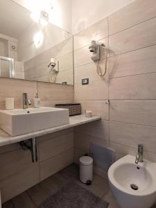 a bathroom with a sink and a mirror and a toilet at SeaBreeze Vernazza in Vernazza
