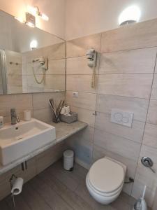 a bathroom with a white toilet and a sink at SeaBreeze Vernazza in Vernazza