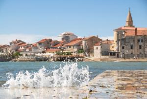 una fuente de agua en un muelle frente a una ciudad en Apartment in Savudrija with sea view, terrace, air conditioning, Wi-Fi (123-7), en Savudrija