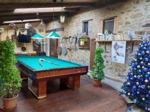 a room with a pool table and a christmas tree at Country House Podere Lacaioli in Castiglione del Lago