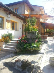 a house with a bunch of flowers in front of it at Ecochiocciola in Montese