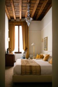 a bedroom with a large bed and a chandelier at Ca' San Giorgio B&B in Venice