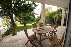 een houten tafel en stoelen op een terras bij Apartments Viganj (22) in Viganj