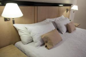 Cama ou camas em um quarto em Argentino Hotel