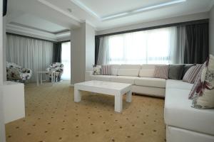 a living room with a white couch and a table at NK Hotel in Izmir