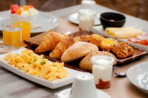 a table topped with plates of breakfast foods and drinks at Hotel El Tejar & Spa in Vilaflor