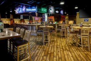 a restaurant with wooden tables and chairs at The Hotel by Gold Dust in Deadwood