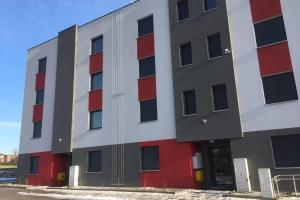 a large building with red and white at Apartament Fibra Brownie in Rybnik