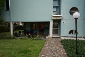 a blue building with a street light in front of it at Residence Parmigianino in Parma